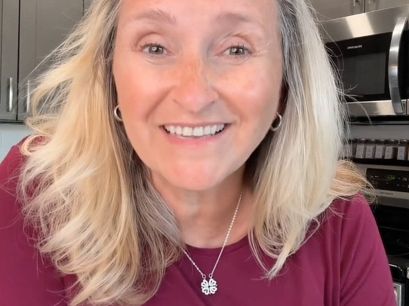 A grandmother who gave her granddaughter the necklace, wearing her own clover pendant