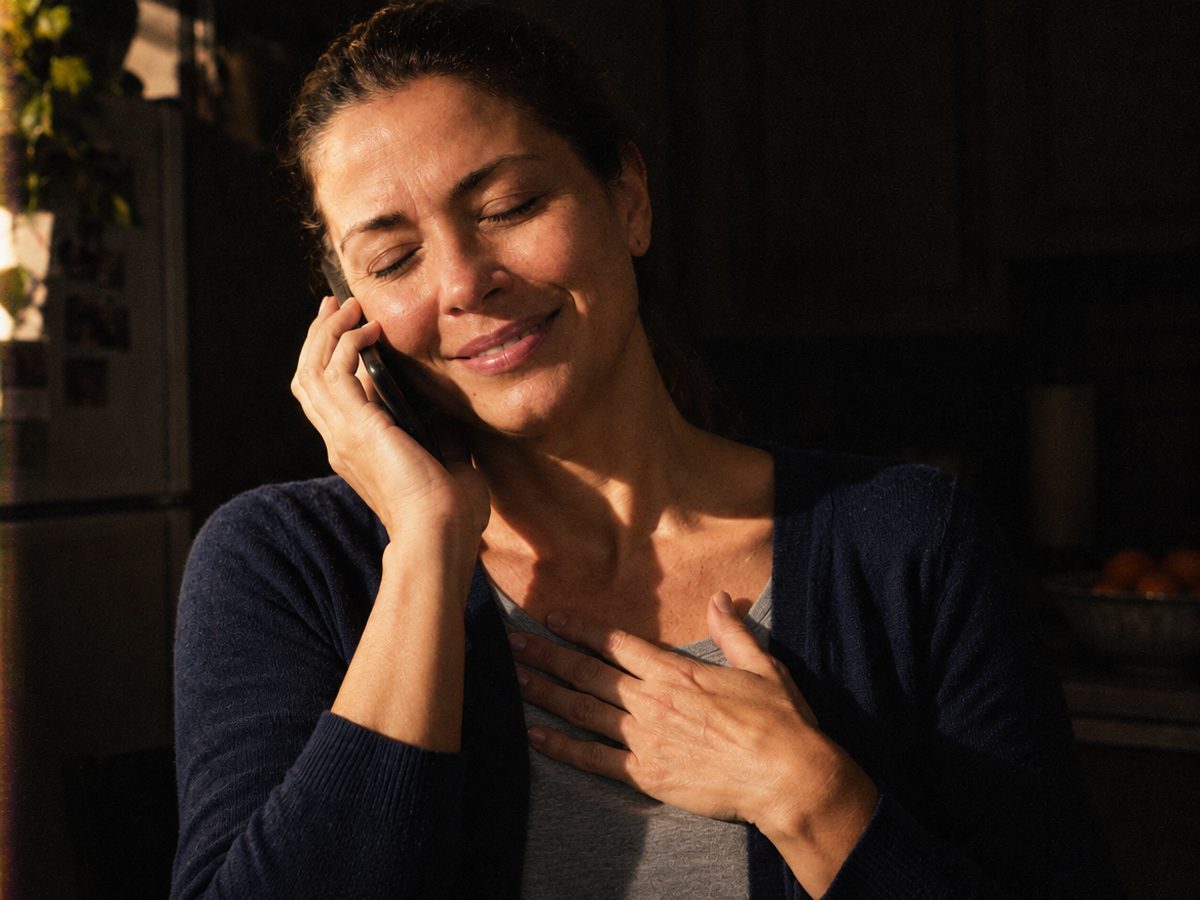 The founder in her kitchen on the phone, hand on her heart